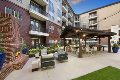Outdoor seating area with a fireplace and gardens