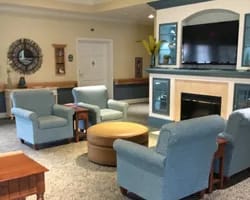 Saint Luke Lutheran Home – North Canton, Nursing Home in North Canton, OH — Cozy lounge area with blue chairs and a television