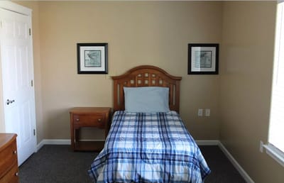 A private resident room with a bed and wall art