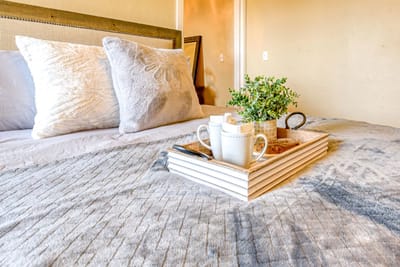 Cozy bedroom setup with decorative items and drinks