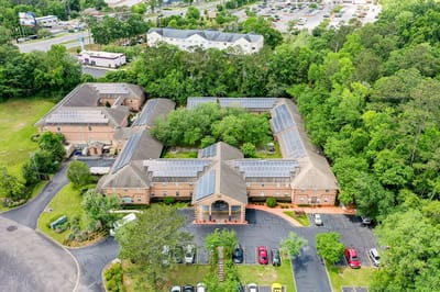 Aerial view of a senior living facility surrounded by trees
