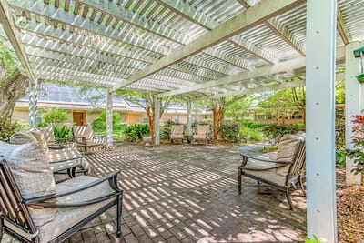 Shaded outdoor seating area with comfortable chairs