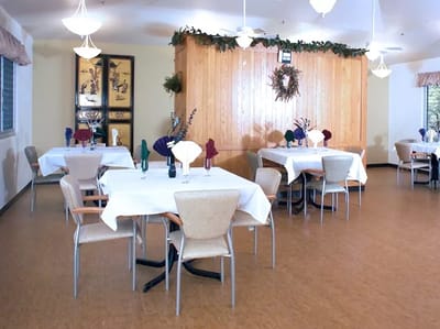 Dining area with tables and chairs set up for meals