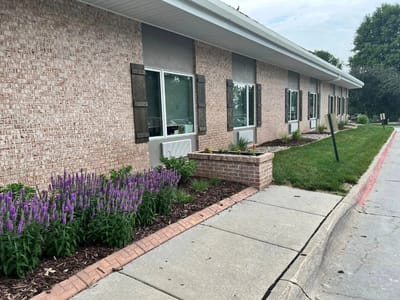 Exterior view of a nursing home building with flowers