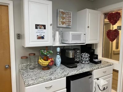 Well-furnished kitchen area with coffee and snacks