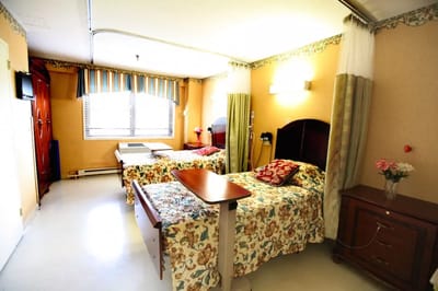 A cozy resident room with two beds and decor
