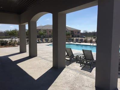 View of the outdoor pool area with lounge chairs