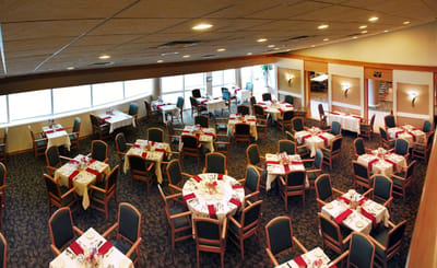Dining room setup with tables and chairs arranged