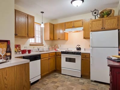 Well-lit kitchen with modern appliances and wooden cabinetry