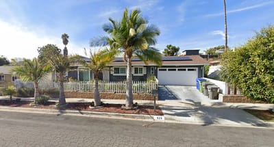 Exterior view of a senior care facility with palm trees
