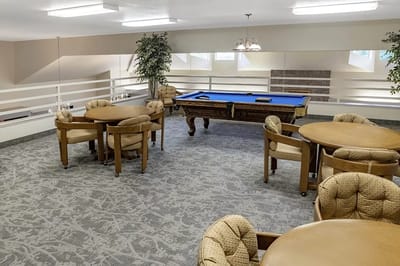 Interior view of a common area with pool table and seating
