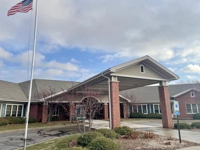 Front entrance of Parkside Manor with flag