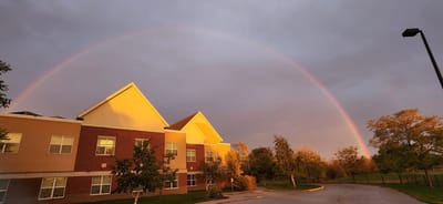 Building exterior with a rainbow in the background