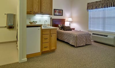 Interior view of a private resident room with kitchenette