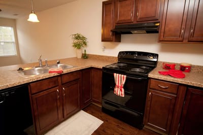 Corner of a modern kitchen with appliances and cabinetry