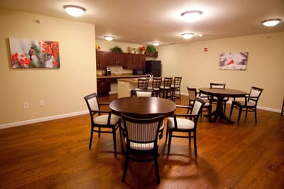 Common area with dining tables and kitchenette