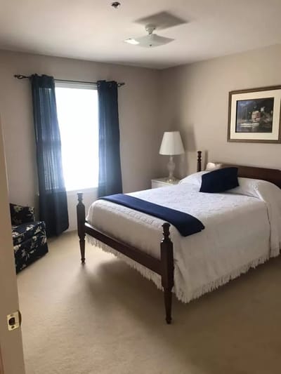 Cozy private resident room with a bed and seating area