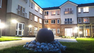 Outdoor space featuring landscaping and building facade