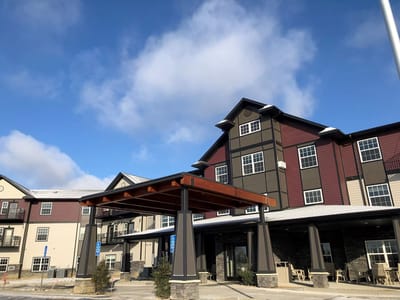 Exterior view of Pelican Landing with an entrance