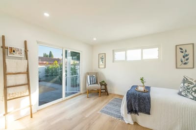 Bright interior of a room with a bed and chair