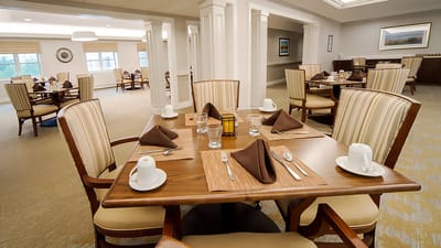 Dining room with set tables and glasses