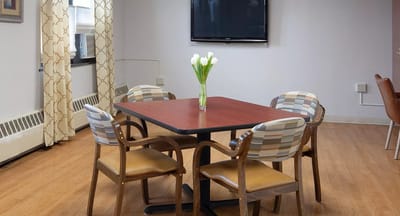 Common area with table and chairs in a well-lit room