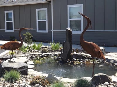 Outdoor garden feature with sculptures and water element
