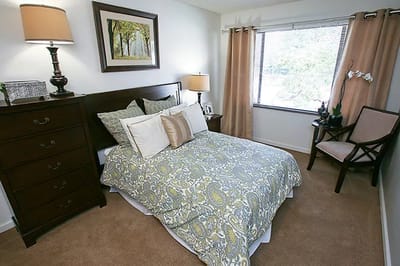 Well-decorated private resident room with bed and furnishings