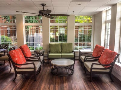 Bright common area with seating and large windows