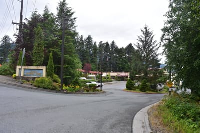 Pioneers‘ Home Juneau, memory care in Juneau, AK — Entrance of a senior living facility surrounded by trees