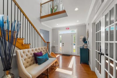 Bright lobby area with staircase and seating