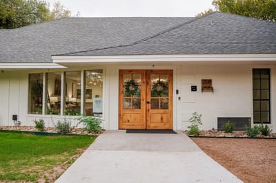 Exterior view of the facility entrance with wooden doors