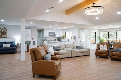Bright common area with comfortable seating and open kitchen