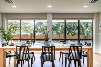 Modern dining area with large windows and outdoor view