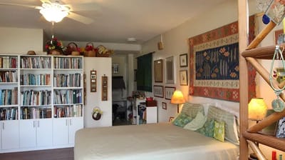 A cozy interior view of a resident room with bookshelves