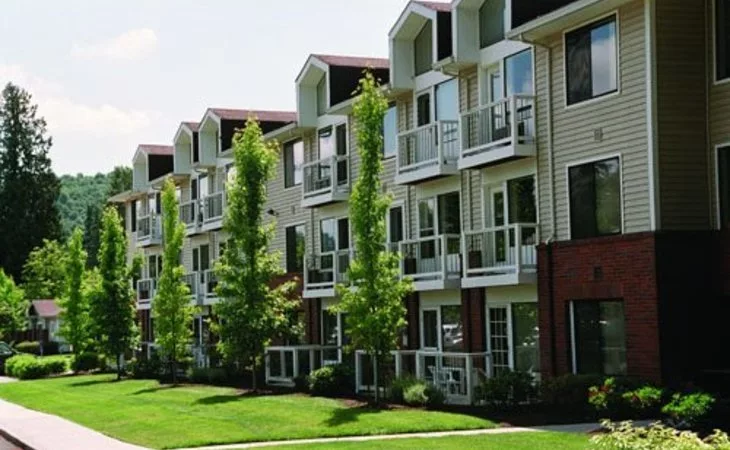 Exterior view of the assisted living facility with green landscape