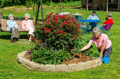Residents enjoying gardening in the outdoor area