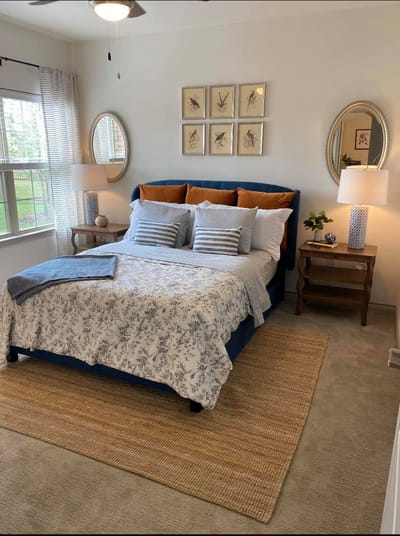 Cozy bedroom setup with floral bedspread and decorative elements