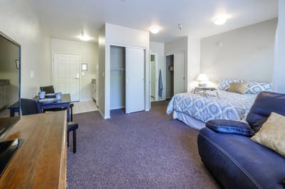 Comfortable resident room with a bed and sitting area