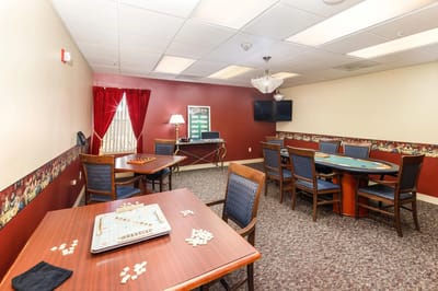 Interior activity room with tables and chairs