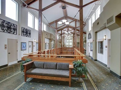 Interior view of a common area with a wooden railing