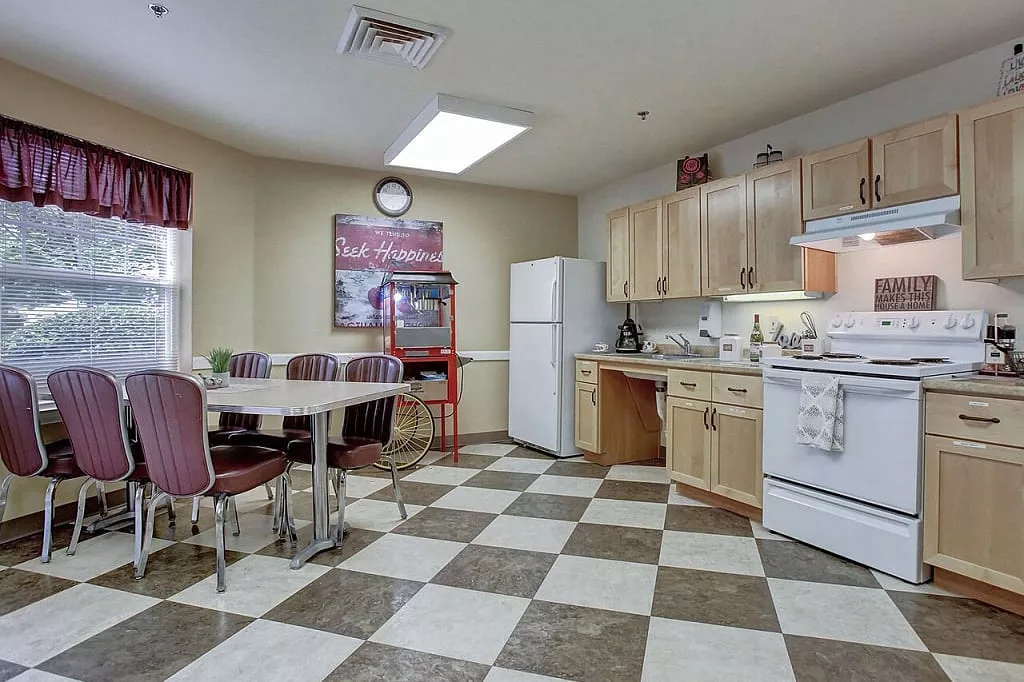 Bright kitchen area with dining table and appliances