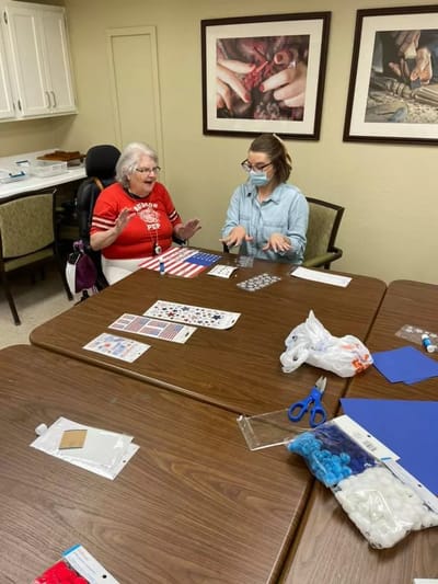 Residents engaged in a craft activity at a table