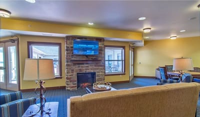 Interior common area with seating and a fireplace