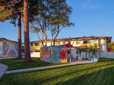 Outdoor space with colorful murals and seating areas