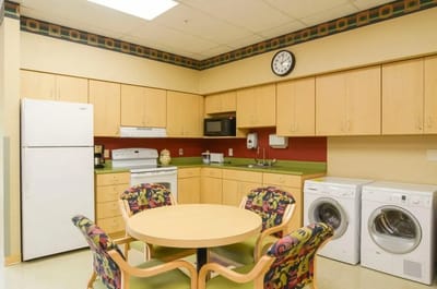 Bright and clean kitchen area with laundry facilities