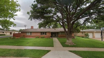 Exterior view of an assisted living facility with landscaped front yard