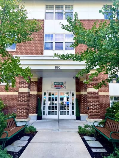 Facade of Providence House Assisted Living with benches and greenery