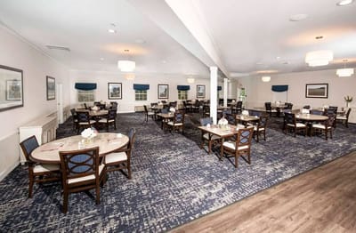 Dining area with tables and chairs set for meals
