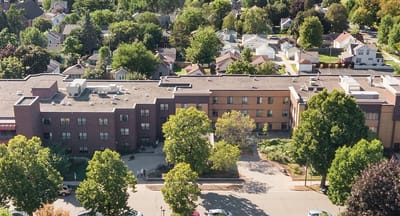 Aerial view of a senior living facility surrounded by greenery